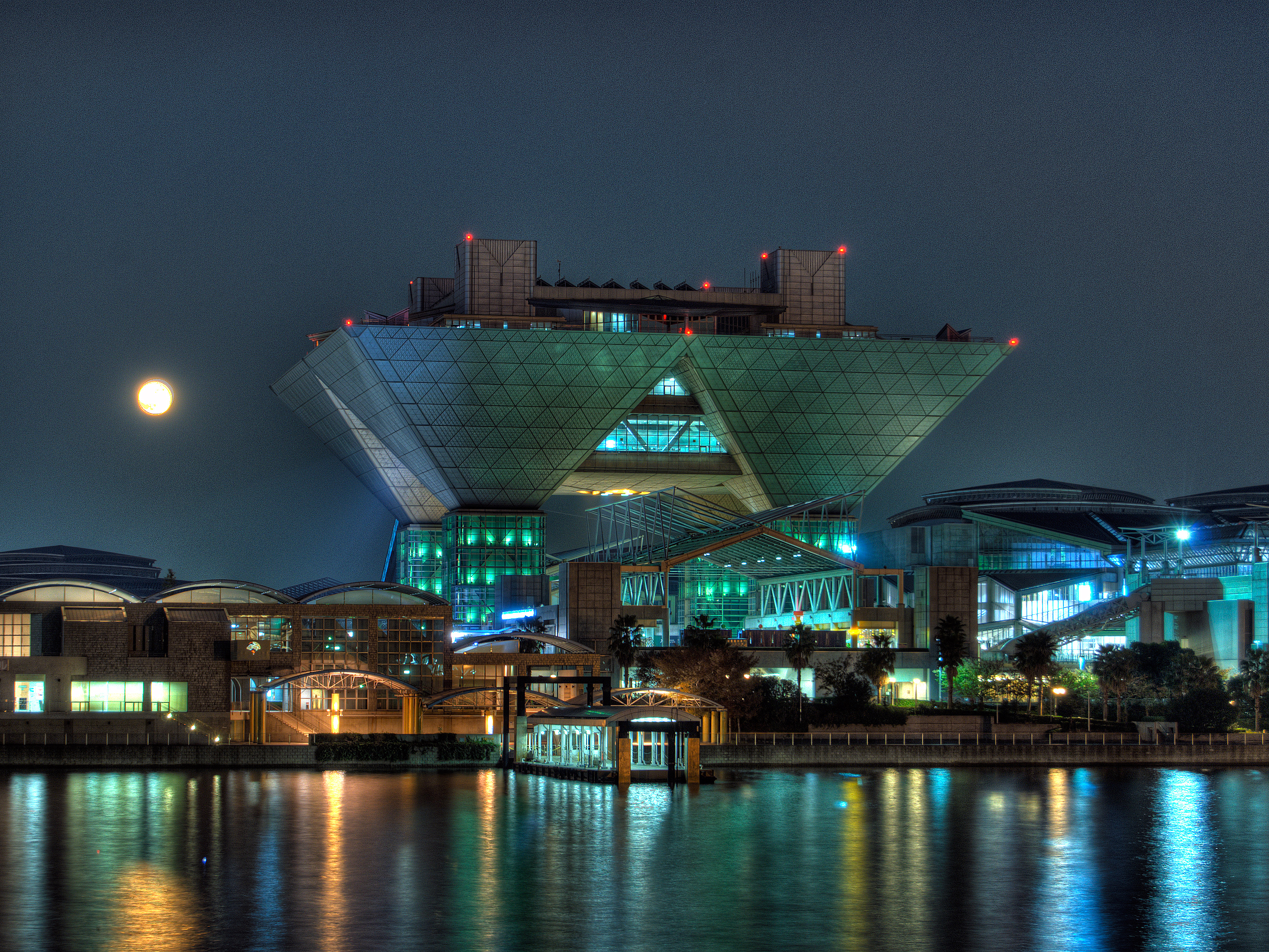 Tokyo Big Sight lit up at night, hosting an anime industry event